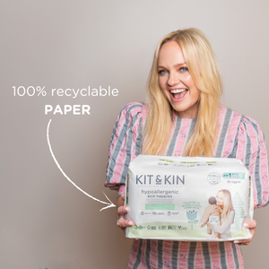 Emma Bunton holding up a pack of size 1 Kit & Kin eco nappies in new paper packaging