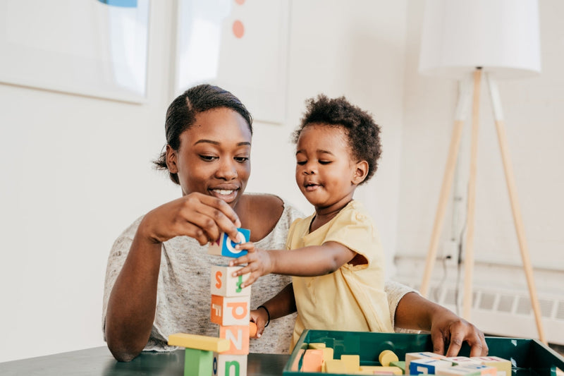 Baby and toddler engaging in simple sensory play activities at home with everyday objects