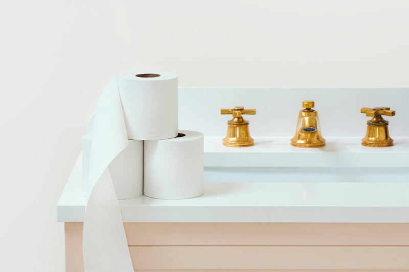 Kit & Kin’s 100% recycled toilet paper rolls stacked in bathroom
